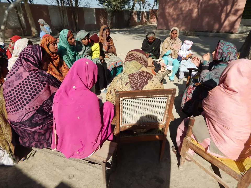 Women of a community organisation meeting in a circle