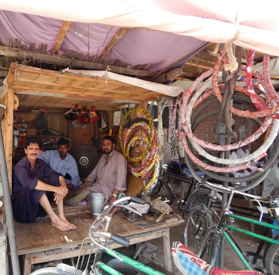 Men at work in a cycle and rickshaw repair workshop